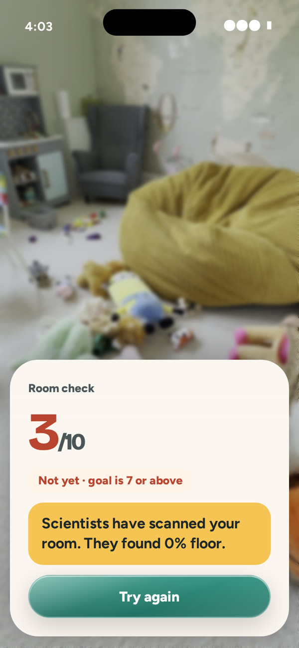 Phone screen: room check 3 out of 10, not yet, with a joke about the messy floor